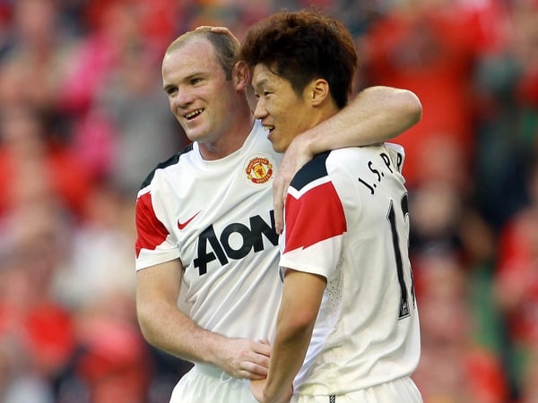 Ji-sung Park is congratulated by Wayne Rooney after scoring the first goal at the new Aviva Stadium