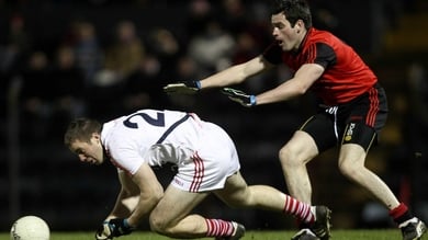 Cork's Colm O'Neill gets to the ball ahead of Down's Aidan Branagan