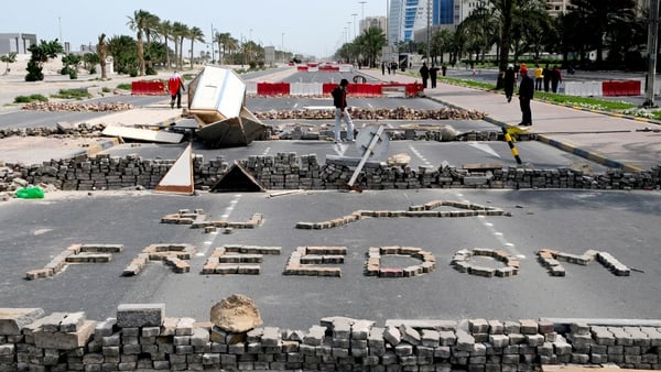 Bahrain - Anti-government protestors stand close to makeshift roadblocks