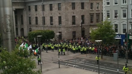 Garda holds a riot shield as protestors are stopped in a street in Dublin,  after Britain's Queen Elizabeth II arrived in the country for a four day  state visit Stock Photo 