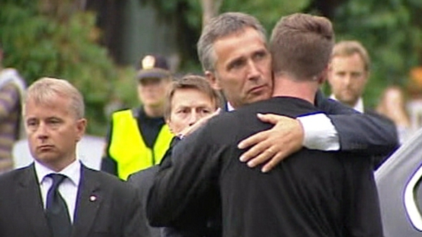 Jens Stoltenberg comforts Eskil Pedersen, the leader of the Norwegian Labour Youth league