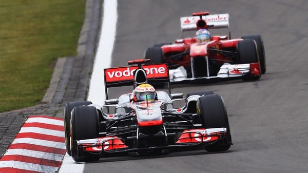 Lewis Hamilton (front) won the German Grand Prix, with Fernando Alonso (behind) finishing second