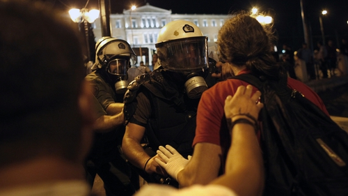 Protesters fight with riot police during clashes at the central Athens Syntagma square last night