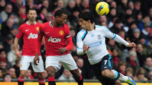 Luis Suarez (R) was banned for eight games for racial abuse of Patrice Evra (C) in 2011