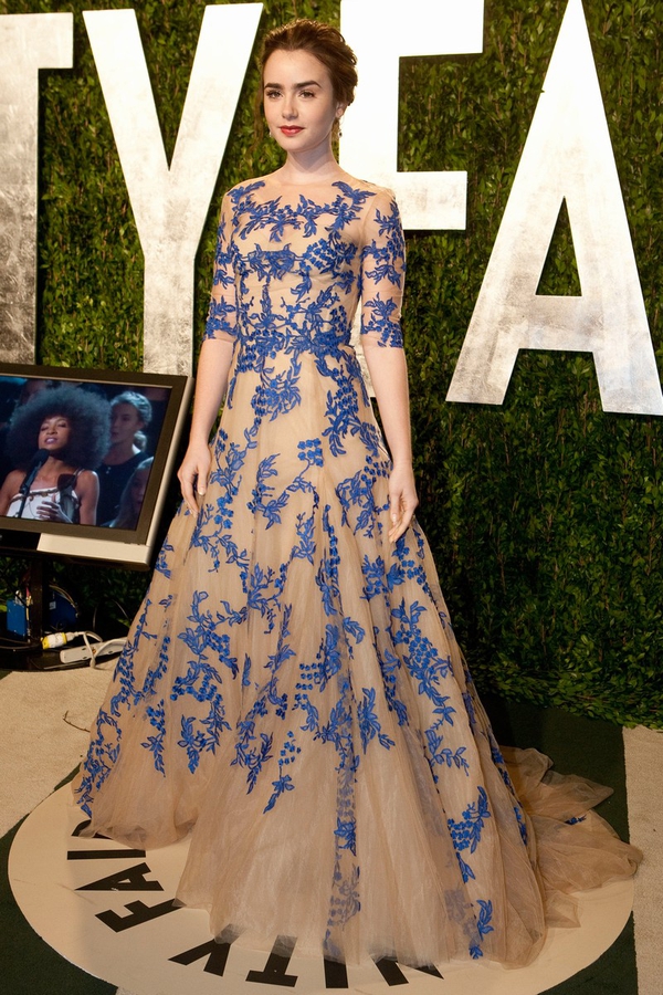 Lily Collins: Taking a huge risk in nude Monique Lhuillier with blue foral appliqué, Lily looks dazzling in this brave gown