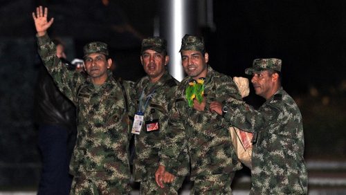 Freed Colombian army sergeants arrive at a military airport in Bogota