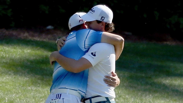 Sergio Garcia hugs Rory McIlroy after they both made birdie on the 12th hole during the third round of The Masters