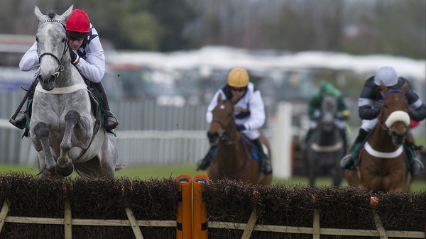 Simonsig (red cap) on his way to victory in the opener on Grand National Day