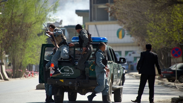 Afghan police head to the scene of an attack in Kabul