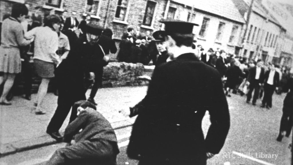 RUC officers stand over a man on a street in Derry 5 October 1968.

© RTÉ Stills Library 0130/059