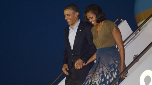 US President Barack Obama and First Lady Michelle Obama step off Air Force One upon arrival at Chicago O'Hare International Airport