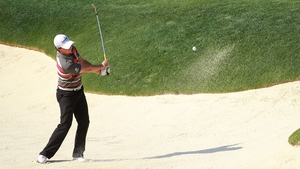 Rory McIlroy extricates himself from a bunker on the 12th hole at Muirfield Village