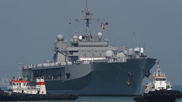 Vietnamese pilot boats guide the US 7th Fleet's flagship USS Bleu Ridge entering Tien Sa port in April
