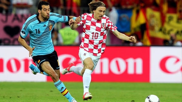 Croatia's Luka Modric shields possession from Sergio Busquets of Spain