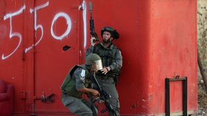 Israeli troops take cover in clashes with Palestinian protesters