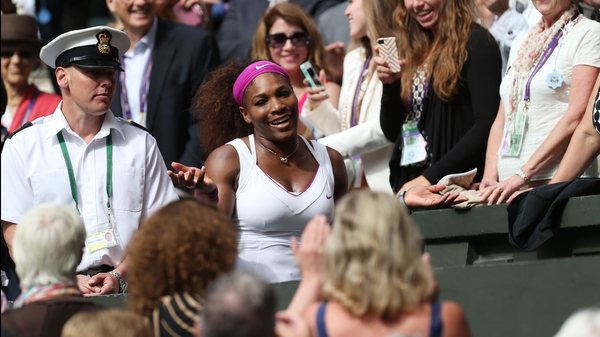 Serena Williams makes her way to the players' box