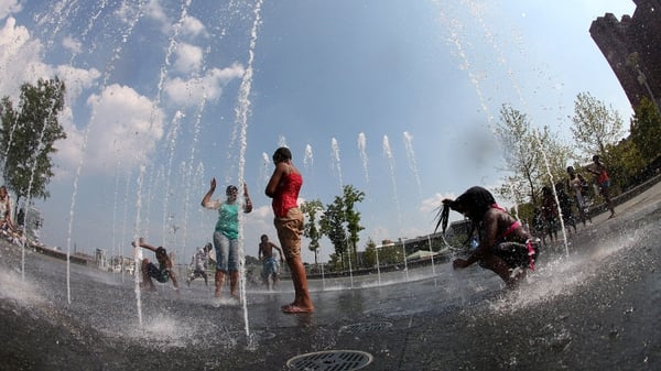A group of people cool off in a fountain at the Inner Harbour in Baltimore
