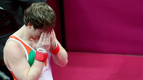 Kieran Behan holds his head in his hands after the floor event