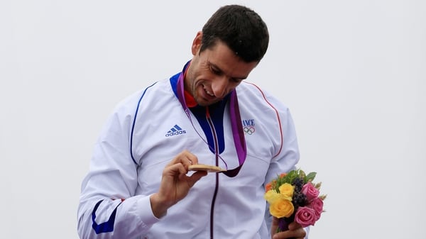 Tony Estanguet admires his gold medal