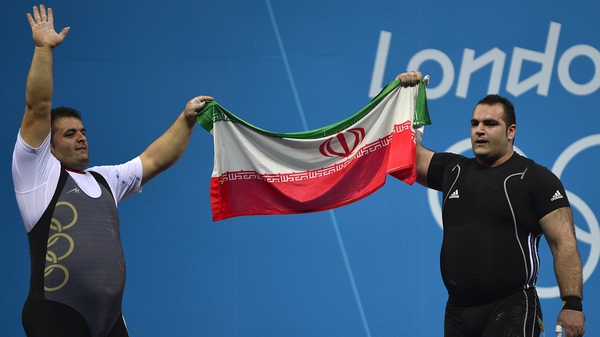 Behdad Salimikordasiabi (R) of Iran celebrates winning the gold medal with compatriot Sajjad Anoushiravani Hamlabad