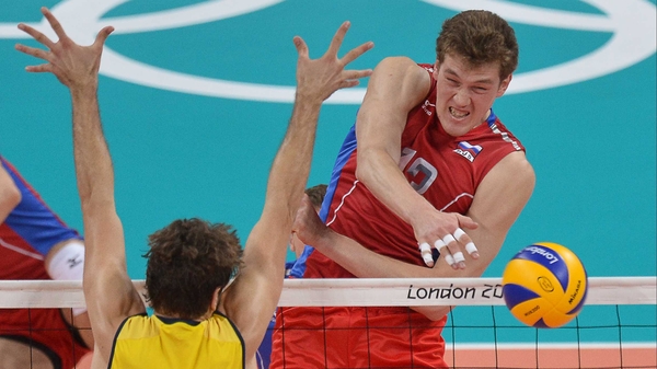 Russia's Dmitriy Muserskiy spikes the ball past Brazil's Lucas Saatkamp