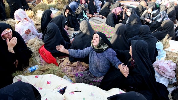 Iranians mourn over bodies of loved ones near the town of Varzaqan