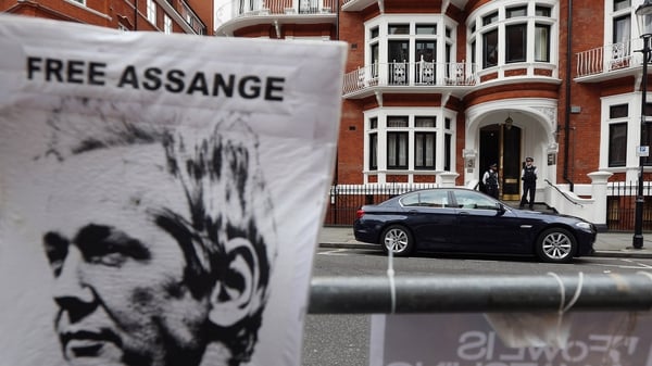 Police stand guard outside the Ecuadorian Embassy