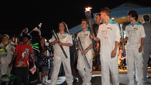 Torchbearers exchange the Paralympic flame outside Stoke Mandeville Spinal Unit
