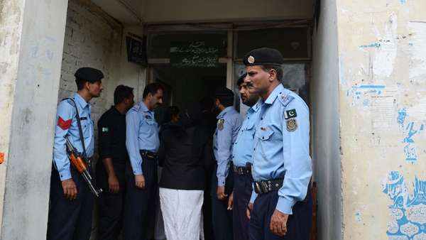 Pakistani policemen stand guard outside a court during the case hearing of a Christian girl accused of blasphemy