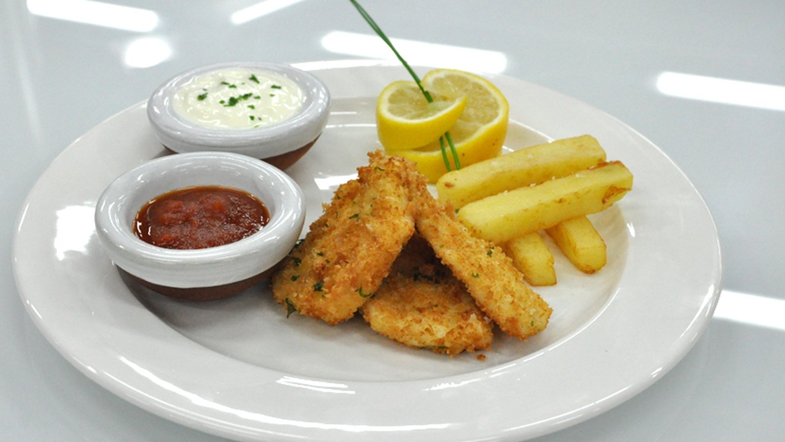 Fish and chips, with Lemon Crème Fraiche and Tomat