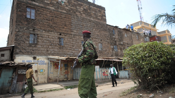 A policeman stands guard next to the site where a blast ripped through a church in Nairobi