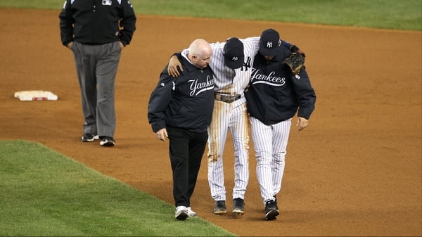 Derek Jeter of the New York Yankees is carried off after fracturing his ankle