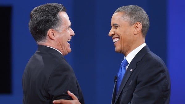 Barack Obama and Republican candidate Mitt Romney shake hands at the end of the third and final presidential debate