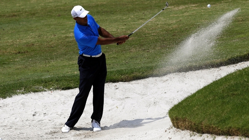 Tiger Woods is in a tie for seventh three strokes back