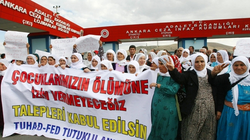 Kurdish women hold a banner reading 'We will not let our children die' as they demonstrate outside a prison in Sincan, near Ankara