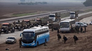 Israeli reserve soldiers and army vehicles depart the Gaza border area following Wednesday's truce