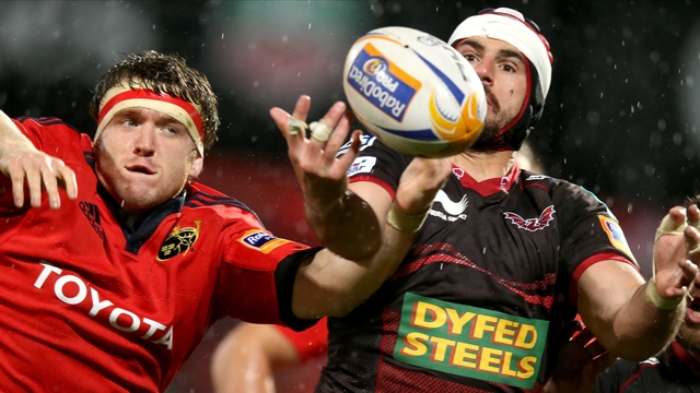 Munster's Mike Sherry with Richard Kelly of Scarlets 