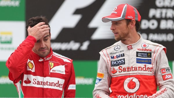 Jenson Button (R) will race alongside Fernando Alonso at McLaren next season