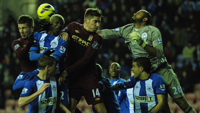 Ali Al Habsi and Jean Beausejour of Wigan battle with Javi Garcia and Matija Nastasic of Manchester City 