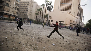 Protesters face Egyptian riot police during clashes on Omar Makram Street, off Tahrir Square, in Cairo
