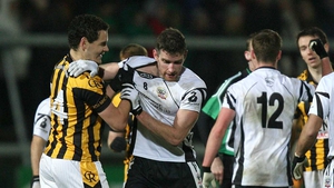 Aaron Cunningham of Crossmaglen Rangers (left) with Paul Greenan of Kilcoo during the Ulster Club SFC final