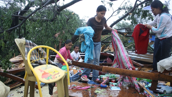 Residents gather their belongings after their house was destroyed by strong winds on the southern island of Mindanao
