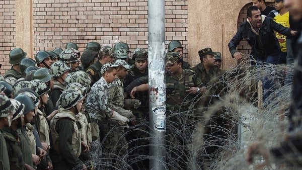 Protesters broke through barbed wire to access the presidential palace
