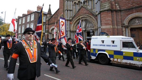 Orangemen march past St Patrick's Catholic Church in north Belfast