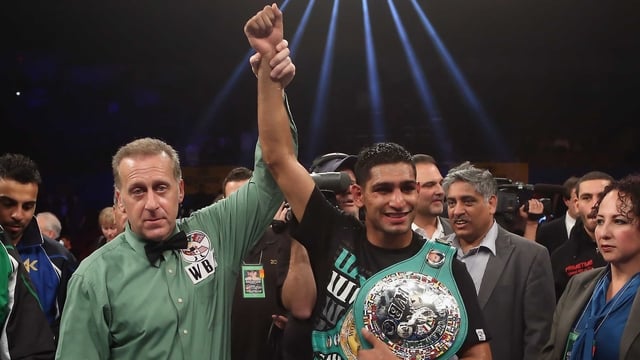 Amir Khan poses with referee Jack Reiss following his vacant WBC silver super lightweight title fight victory over Carlos Molina