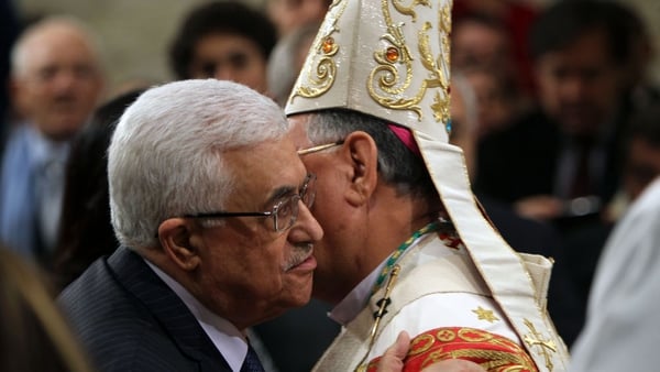 Foud Twal, the Latin Patriarch of the Holy Land, embraced Palestinian President Mahmoud Abbas (l) as the Palestinian Authority leader attended the Christmas midnight mass in Saint Catherine's Church in Bethlehem