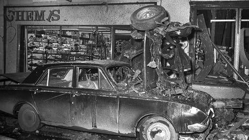 The bomb had been placed in a red Ford Escort car outside Farrelly's Bar and McGowan's Drapery on Main Street
