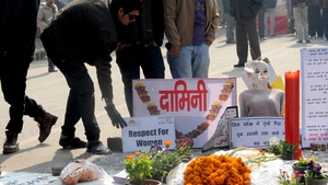 Indian activists stand near a memorial to a rape victim during a protest in New Delhi