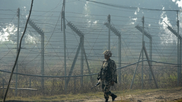 An Indian soldier patrols the border with Pakistan