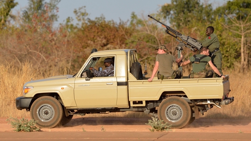 French soldiers sit aboard a Malian military armed car